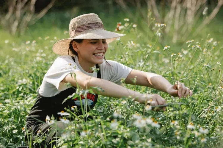 Cheerful woman gardening, illustrating how to maintain good oral health through healthy lifestyle habits.