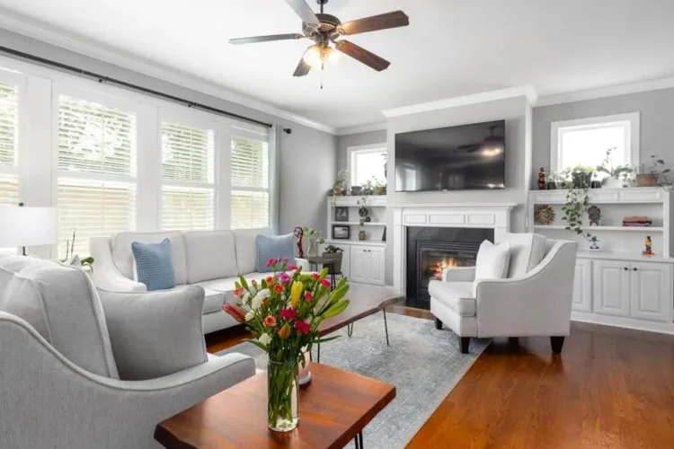 Stylish living room with fireplace highlighting the importance of regular cleanings.