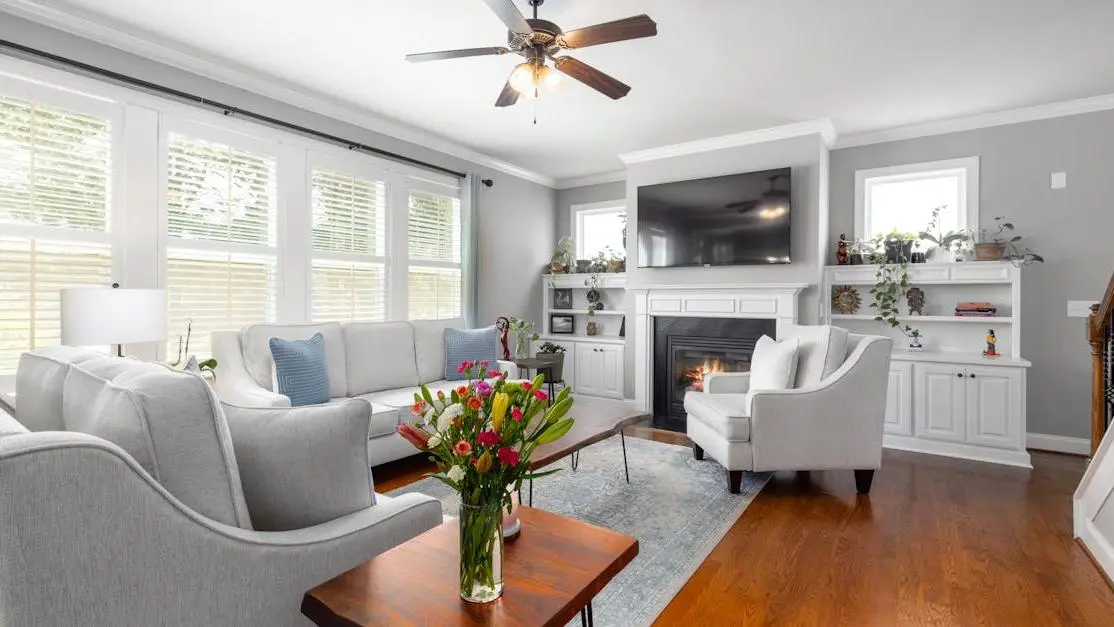 Stylish living room with fireplace highlighting the importance of regular cleanings.