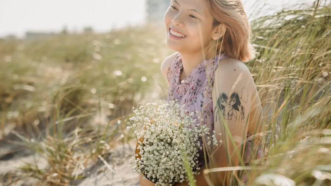 Smiling woman practicing Invisalign teeth care while holding flowers