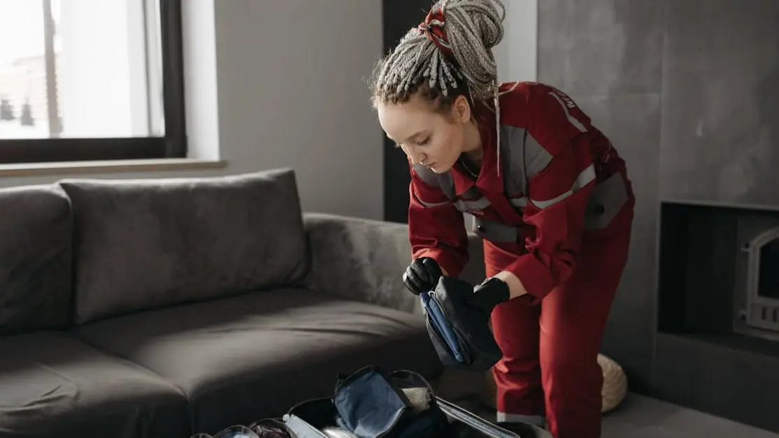 Paramedic prepares medical kit for managing dental emergencies at home indoors.