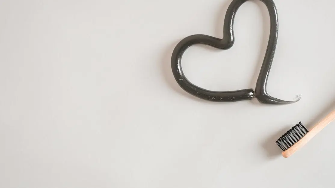 Toothbrush with toothpaste heart symbolizing oral health and heart health correlation