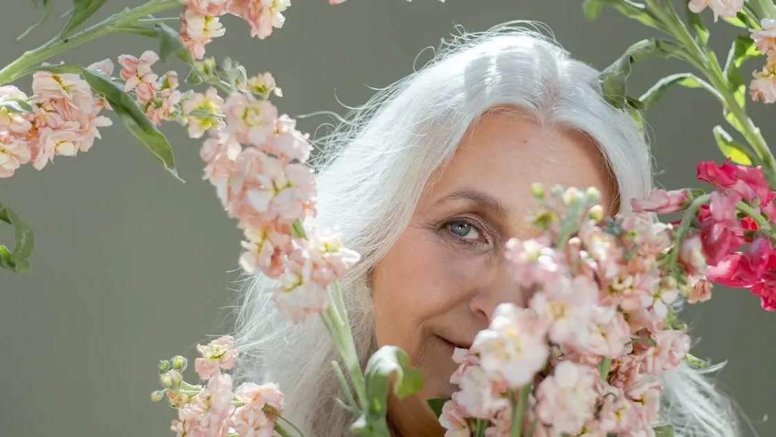 Elderly woman smiling, promoting oral health for seniors.