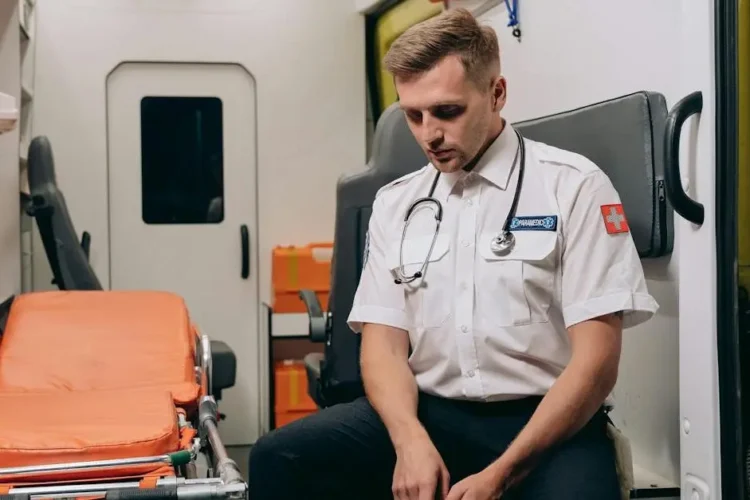 Paramedic resting in ambulance related to orthodontic emergency care.