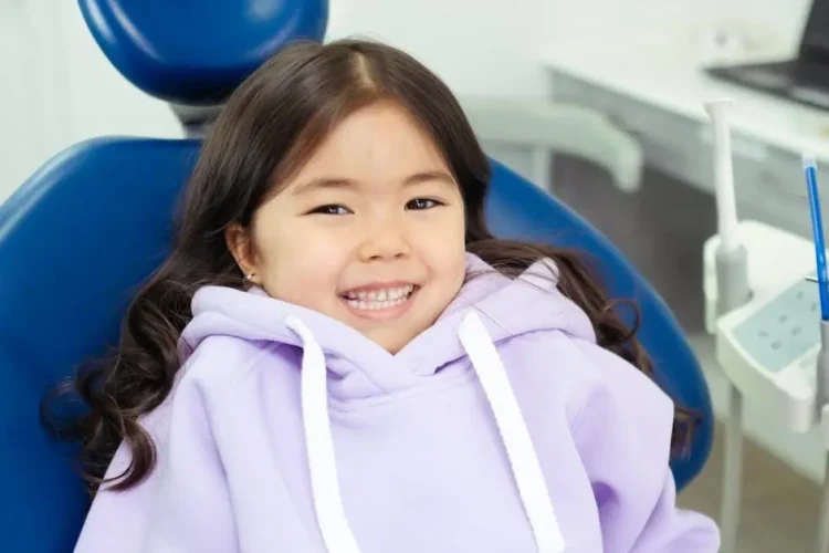 Cheerful child ready for their first dental visit in modern clinic.