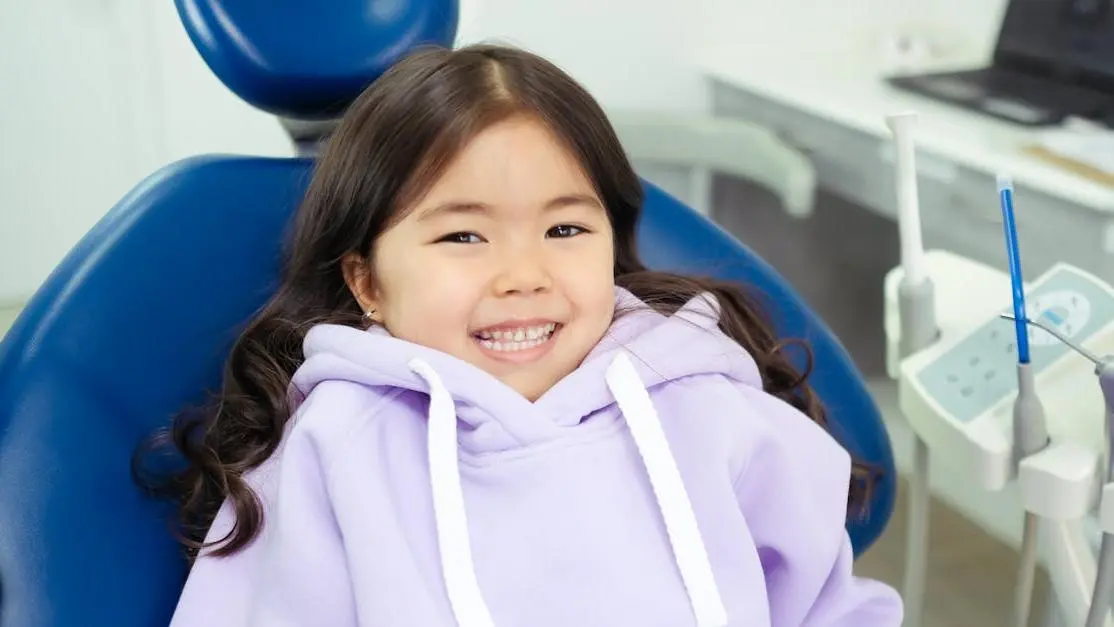 Cheerful child ready for their first dental visit in modern clinic.