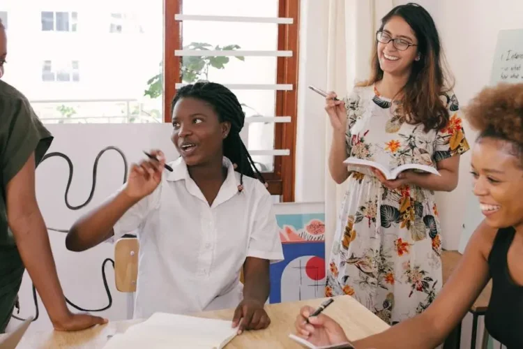 Women laughing while discussing questions about All-on-4 dental implants.