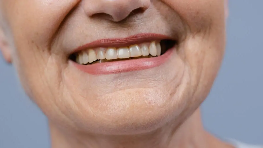 Smiling woman contemplating questions about TeethXpress dental implants.