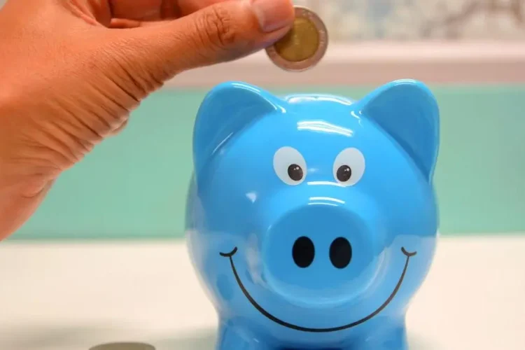 Saving money for root canal therapy cost with coin in piggy bank.