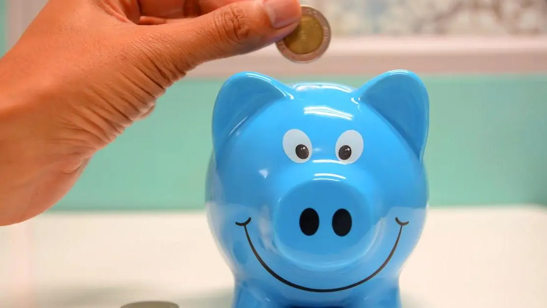 Saving money for root canal therapy cost with coin in piggy bank.