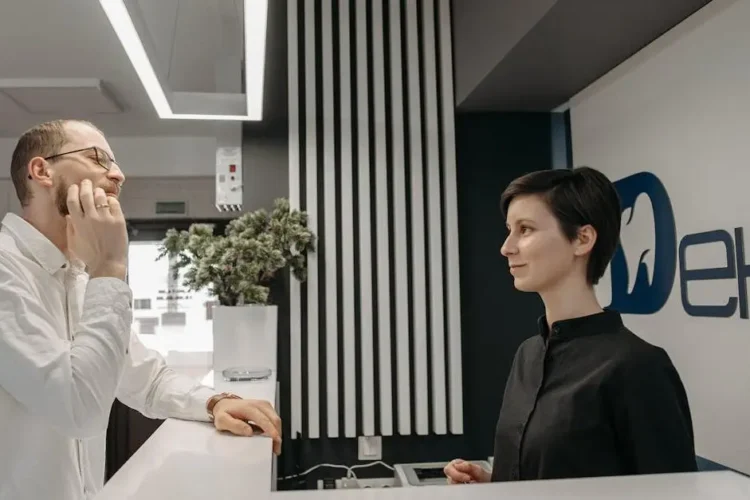 Patient discussing same day dental implants with a dental clinic receptionist