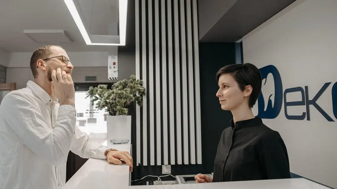 Patient discussing same day dental implants with a dental clinic receptionist