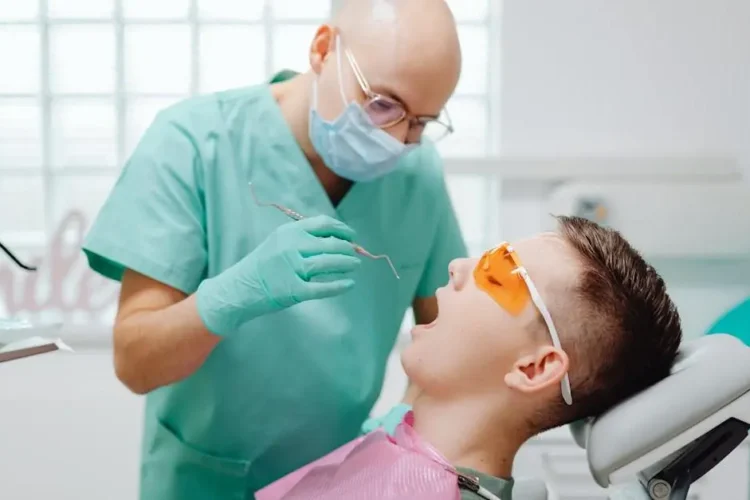 Dentist examines patient during root canal procedure, highlighting what to expect.