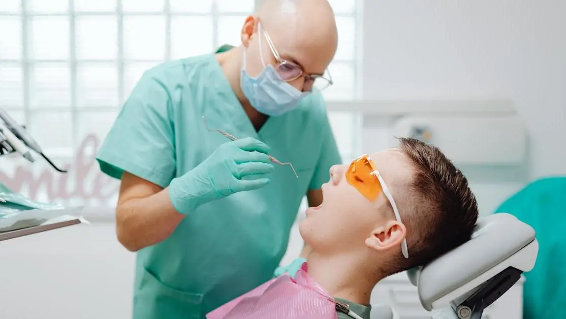 Dentist examines patient during root canal procedure, highlighting what to expect.